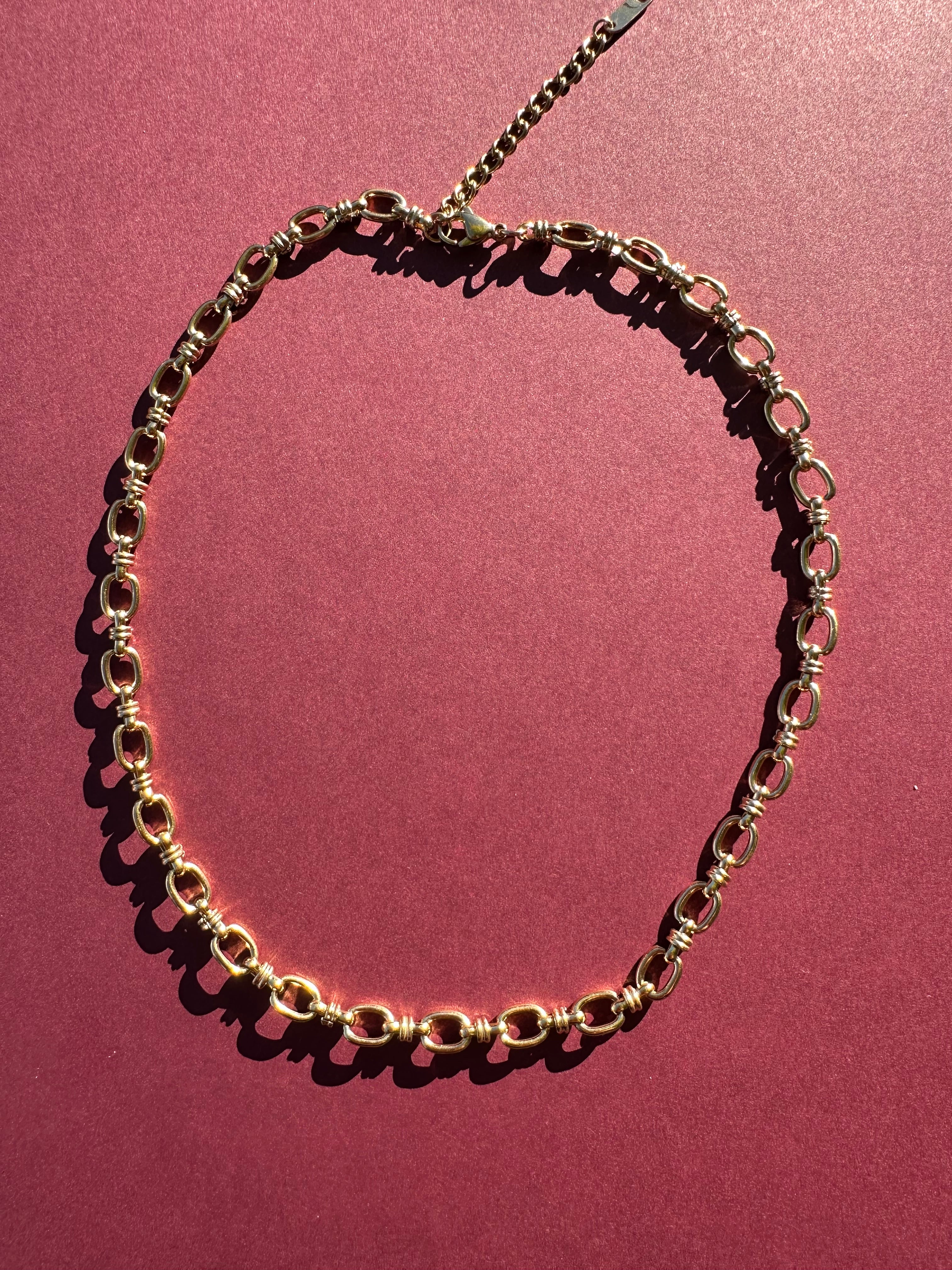 Cable link necklace On maroon background 