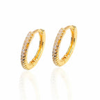 Gold hoop earrings with embedded stones on a white background
