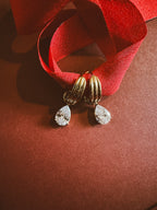 Tear drop Huggie Hoops On maroon background