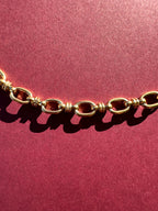 Close up of Cable link necklace On maroon background 