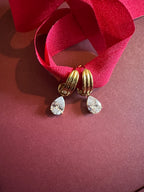 Tear drop Huggie Hoops On maroon background