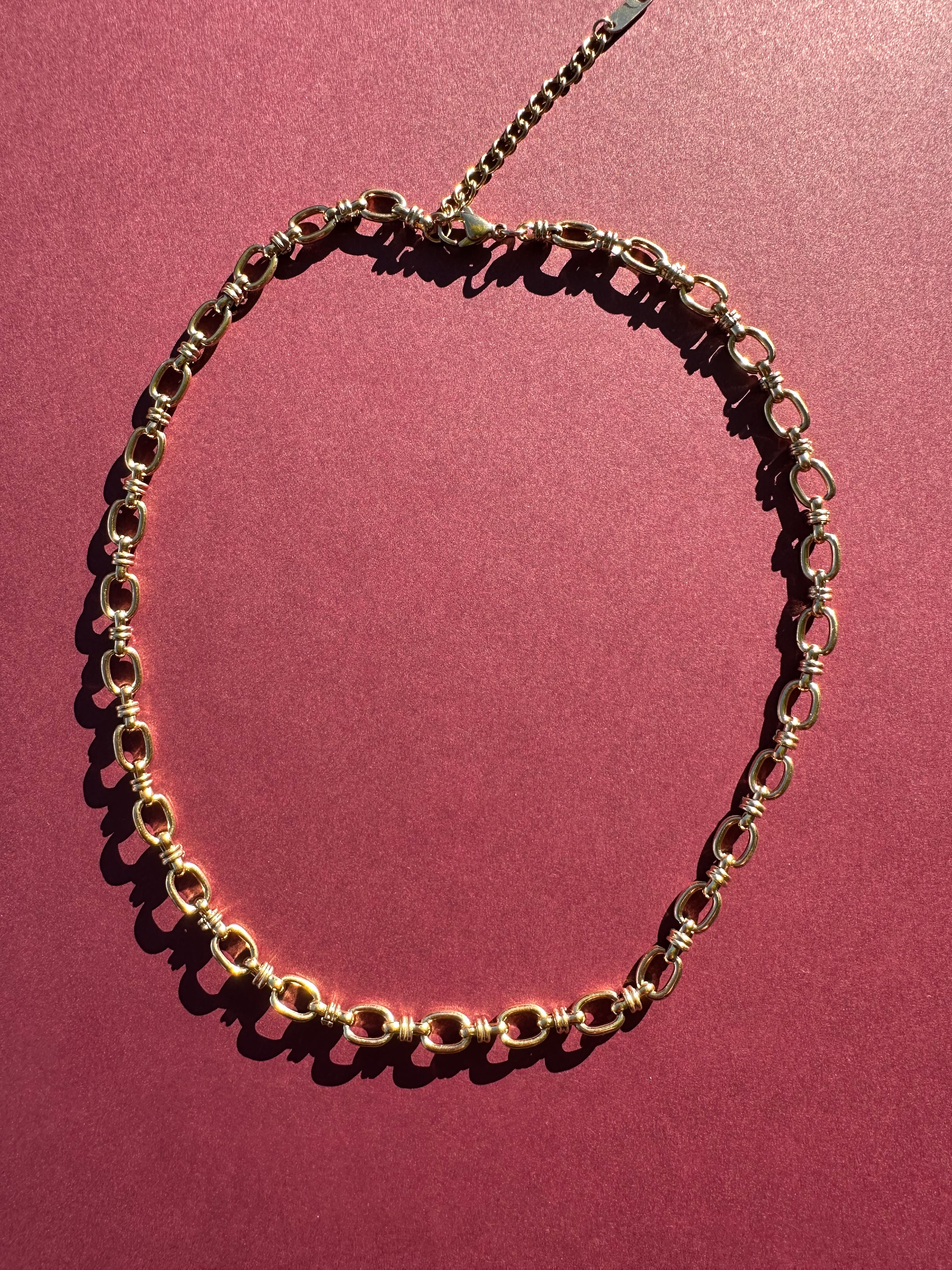 Cable link necklace On maroon background 