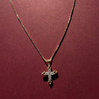 Dainty Cross necklace with maroon background 